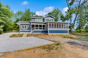 a large blue house with a large driveway at The Point on Williams Court in Union Pier