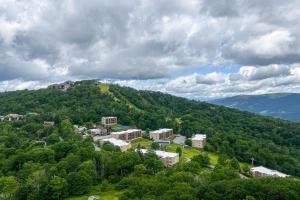 an aerial view of a town in the middle of a mountain at Misty Morning in Sugar Mountain