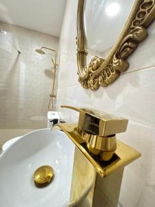 a bathroom with a sink with a gold faucet at Entrecallejones in Carmona +34 photos