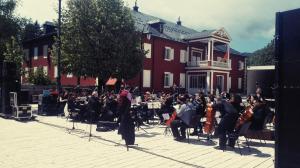 a group of people playing music in front of a building at Apartment The Royal Square in Cetinje