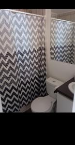 a bathroom with a toilet and a shower curtain at Depto 202 viracocha in Ovalle