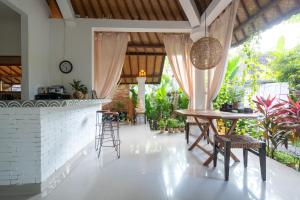 a kitchen with a table and chairs in a room at Vastu Family villa in Ubud