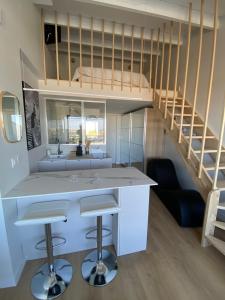 a kitchen with a counter and a bunk bed at Village naturiste Appart B Port Soleil in Cap d'Agde
