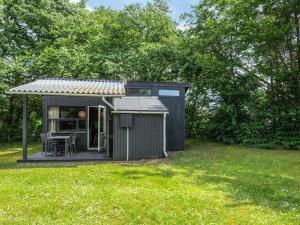 a small shed with a table in a yard at 4 person holiday home in Hampen in Hampen