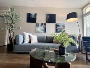 a living room with a couch and a table at Designer 2 Bedroom with 3 Beds- Pool View, Gym, Parking in Los Angeles