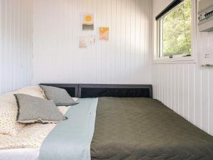 a bedroom with a bed with pillows and a window at 5 person holiday home in Silkeborg in Silkeborg