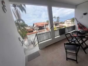 a balcony with a view of a house at Flat novo 06 a pé Prainha de Mambucaba Paraty RJ in Paraty