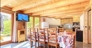 a kitchen and dining room with a table and chairs at Gite Les Tarines 1 in Beaufort +16 photos