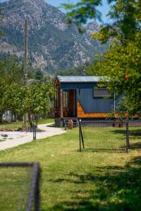 a house in a park with mountains in the background at Marimare Beach & Bungalow in Marmaris