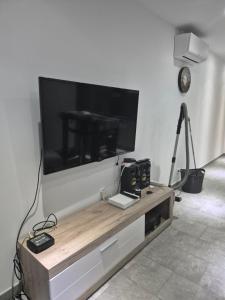 a living room with a large flat screen tv on a wall at Appartement avec terrasse in Vias
