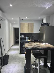 a kitchen with a island in the middle of a room at Appartement avec terrasse in Vias