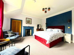 a bedroom with a bed and a couch and a chair at Lochinver Manse Bed and Breakfast in Lochinver