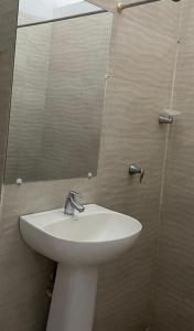 a bathroom with a white sink and a mirror at Morita in Estación El Salto