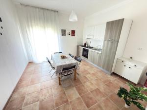 a kitchen and dining room with a table and chairs at La Casa di Giusy Holiday Home in Porto Empedocle