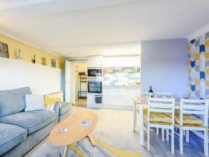a living room with a couch and a table at Awel Y Mor Sea Breeze in Cemaes Bay