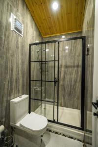 a bathroom with a shower and a toilet and a tub at Marimare Beach & Bungalow in Marmaris