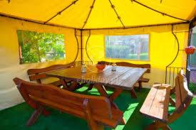 a dining room with a table and benches in a tent at Willa Apollo in Władysławowo