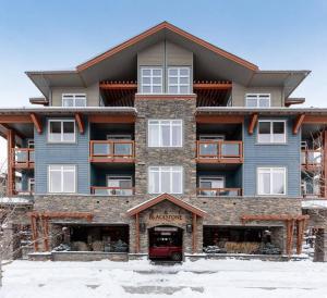 a large apartment building with a van parked in front of it at Mountain Luxe in Canmore +58 photos