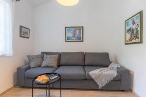 a living room with a couch and a table at Candela, No 3 in Starigrad-Paklenica +27 photos