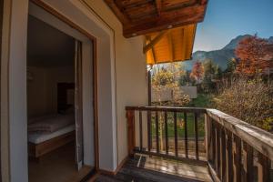 a balcony with a bed and a view of the mountains at Ferienhaus am Rohntalbach in Hinterriss