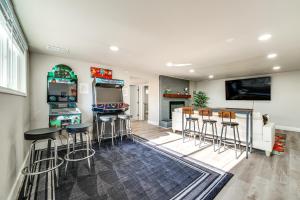a living room with a bar with stools and a tv at 3 Mi to Dtwn Family Home with Garden and EV Charger in Yakima