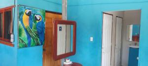 a bathroom with a mirror and a blue wall at Hostal Javier's House sjs in San Juan del Sur +86 photos