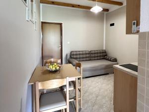 a kitchen and dining room with a table and a couch at Apartments with parking space Starigrad, Paklenica - 11683 in Starigrad +13 photos