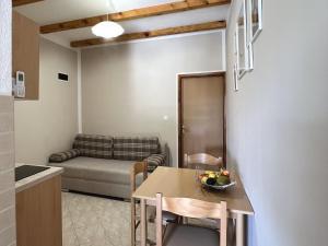 a kitchen and living room with a table and a couch at Apartment Starigrad 11683b in Starigrad