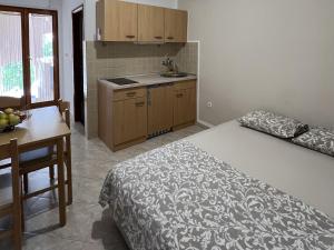 a bedroom with a bed and a table and a kitchen at Apartment Starigrad 11683b in Starigrad +17 photos