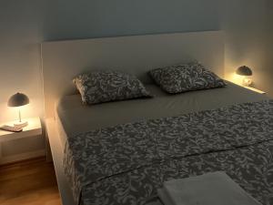 a bedroom with a bed with two pillows on it at Apartment Starigrad 11683b in Starigrad