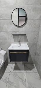 a bathroom with a sink and a mirror on the wall at CLUB 33 FIT Hotel Gym in Huancayo