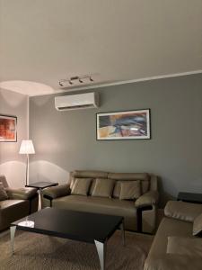 a living room with a couch and a table at dana beach resort in Half Moon Bay