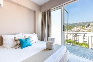 a bedroom with a bed and a large window at Himara City 52 - Central & Beach Access in Himare