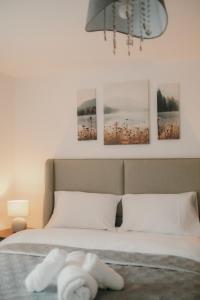 a bedroom with a bed with four pictures on the wall at Modern Stay - Walk to Everything 1 in Ipswich