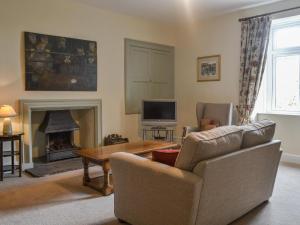 a living room with a couch and a fireplace at East Monkton Farm Cottage in Wick