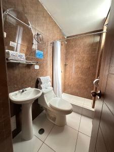 a bathroom with a toilet and a sink and a shower at FRIENDLY AQP in Arequipa