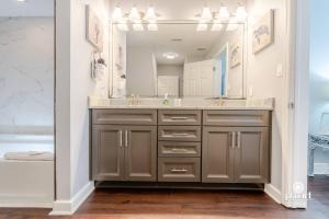 a bathroom with a sink and a large mirror at Vitamin Sea 0.6 miles to beach, monthly disc in Destin +47 photos