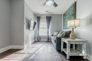 a living room with a couch and a table at Vitamin Sea 0.6 miles to beach, monthly disc in Destin