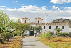 a white building with two domes on top of it at Cortijo de los Castellanos in Las Ventanas