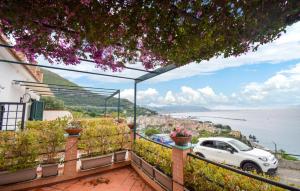 a white car parked on a balcony overlooking the water at Oleandri in Vietri sul Mare