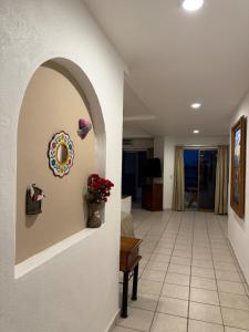 a hallway with a living room with a table at Casa Olas in Puerto Vallarta