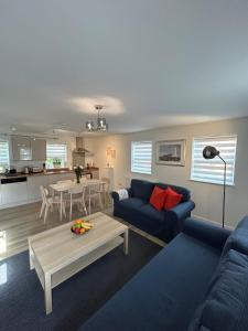 a living room with a blue couch and a table at Modern Stay - Walk to Everything 4 in Ipswich