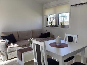 a living room with a table and a couch at 4 star holiday home in BRÅLANDA in Brålanda