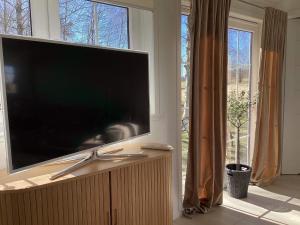 a large flat screen tv in a room with windows at 4 star holiday home in BRÅLANDA in Brålanda