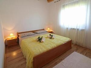 two stuffed animals sitting on a bed in a bedroom at Villa in minj with swimming pool in Žminj
