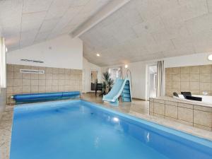 a swimming pool with a slide in a house at 5 star holiday home in Bogense in Bogense