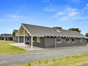 a gray house with a pitched roof at 5 star holiday home in Bogense in Bogense