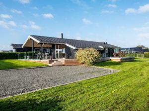 a house with solar panels on the roof at 4 star holiday home in Juelsminde in Sønderby