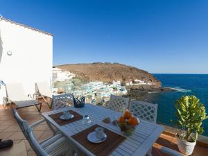 une table sur un balcon avec vue sur l'océan dans l'établissement Apartment in Tufia with Oceanfront Terrace, à Telde