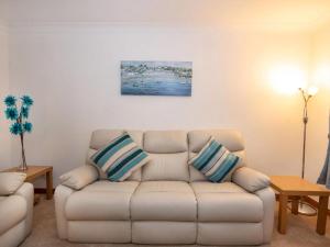a living room with a couch and a painting on the wall at Holm Dell Apartment in Inshes
